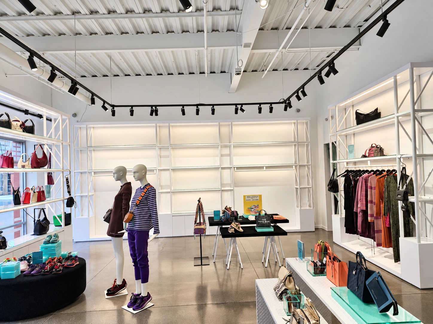 Retail interior with existing black track lighting and white display shelves