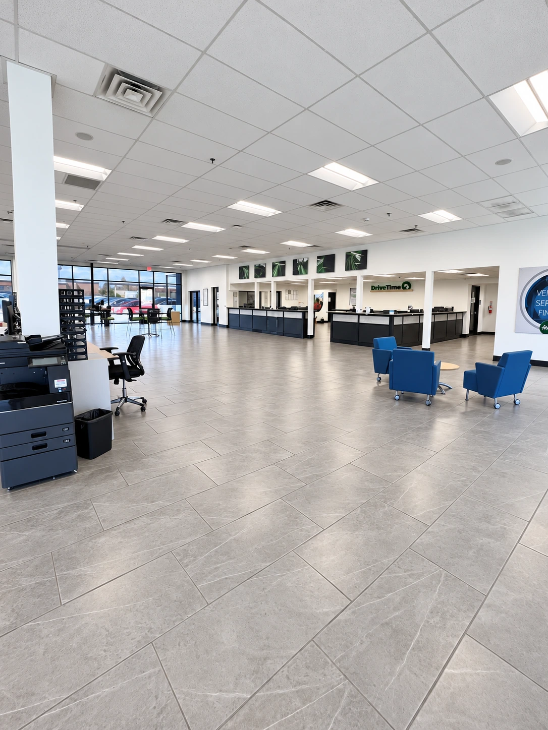 Commercial showroom with ceiling lighting and blue seating
